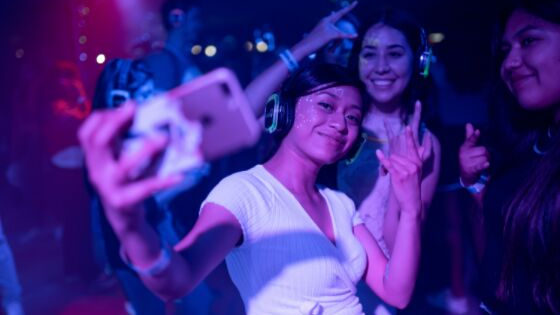 a girl taking a selfie in the party